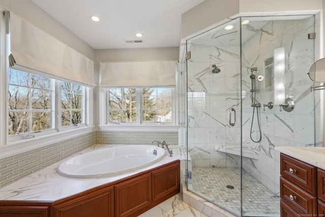 bathroom featuring vanity and separate shower and tub