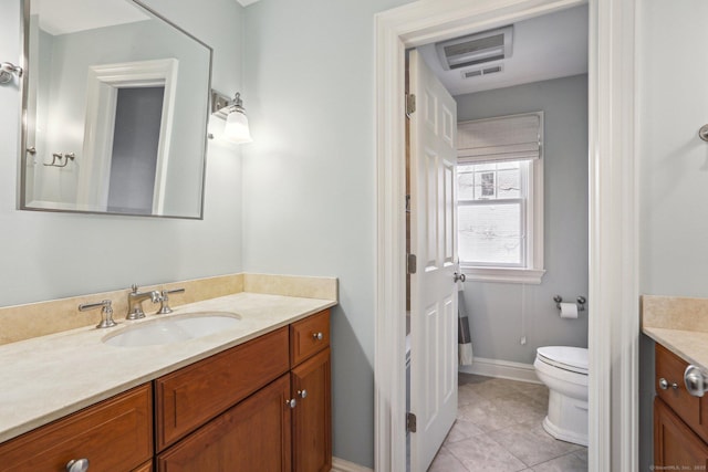 bathroom with tile patterned flooring, vanity, and toilet