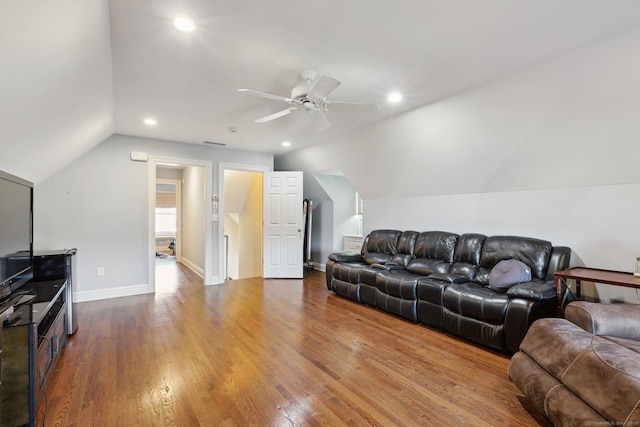 living room featuring lofted ceiling, hardwood / wood-style flooring, and ceiling fan