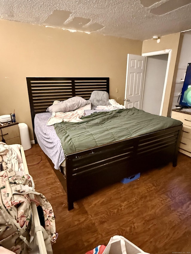 bedroom featuring hardwood / wood-style floors and a textured ceiling