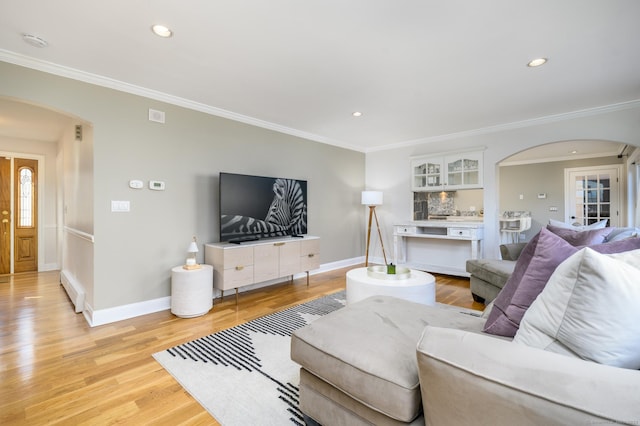 living room featuring light hardwood / wood-style flooring and ornamental molding