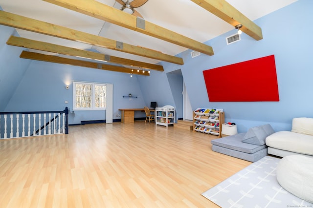 living room with ceiling fan, hardwood / wood-style floors, and lofted ceiling with beams