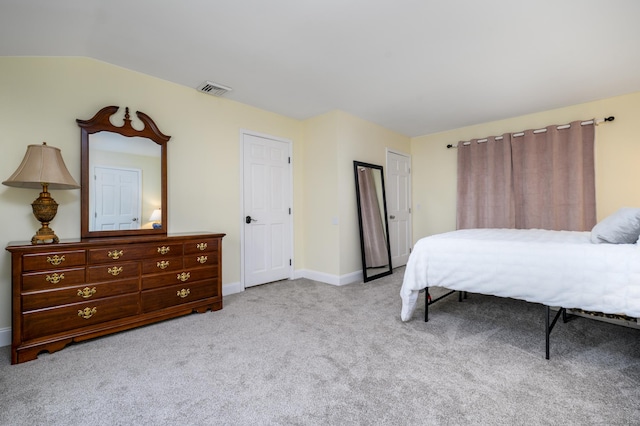 bedroom with light carpet and vaulted ceiling