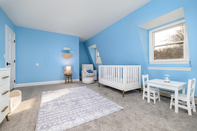 carpeted bedroom with a nursery area