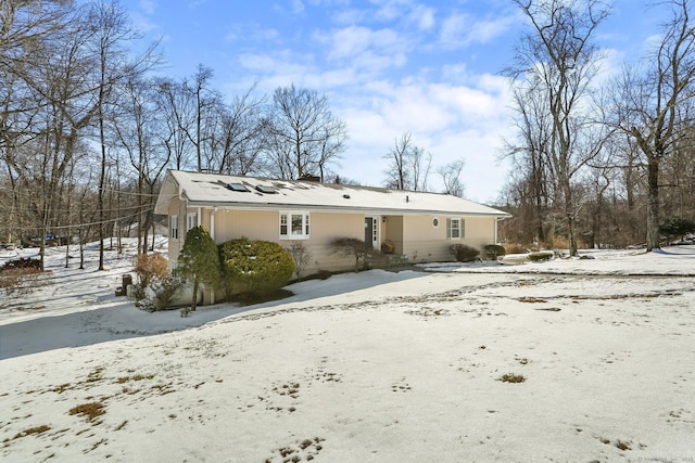 view of snow covered back of property