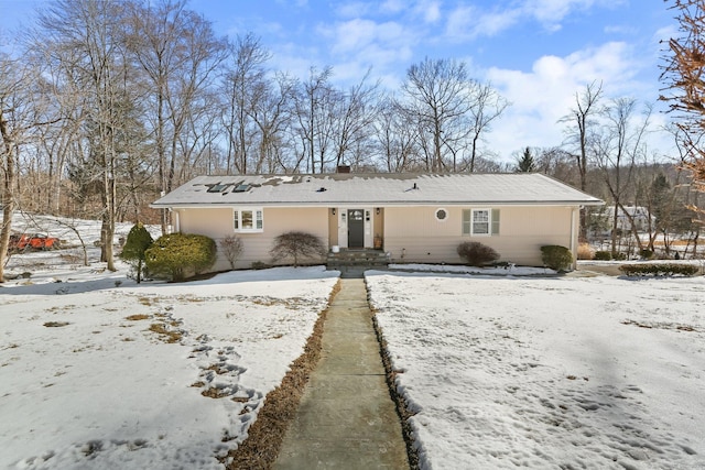 view of snow covered back of property