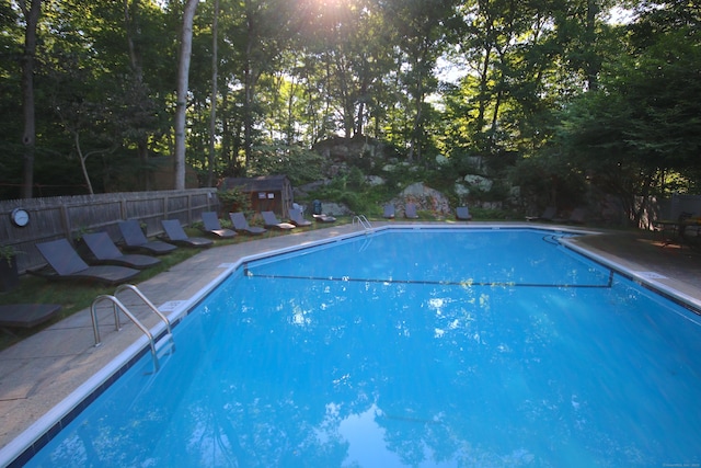 view of swimming pool with a storage shed