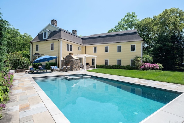 rear view of house featuring a patio, a lawn, and a pergola