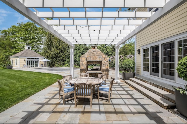 view of patio featuring a pergola, an outbuilding, and an outdoor stone fireplace