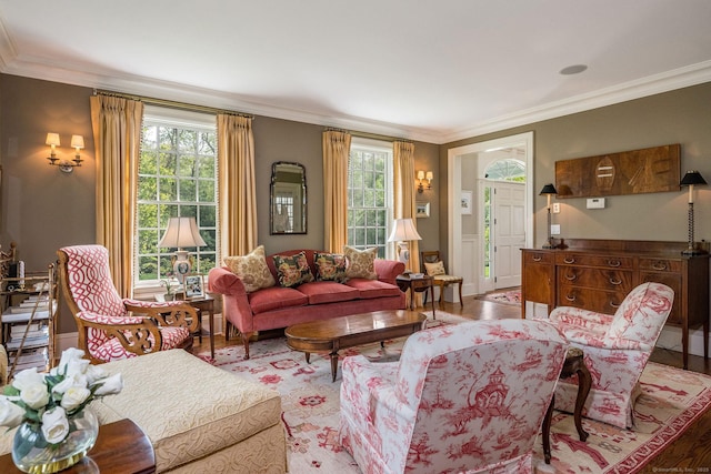 living room with hardwood / wood-style floors, plenty of natural light, and crown molding