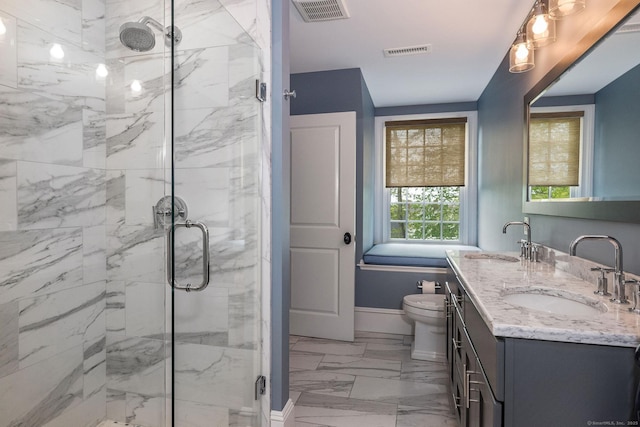 bathroom with a shower with door, vanity, and toilet