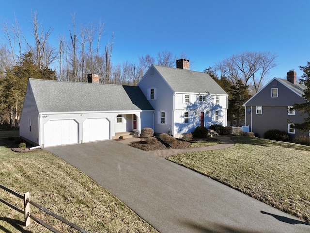 view of front of home with a garage and a front yard