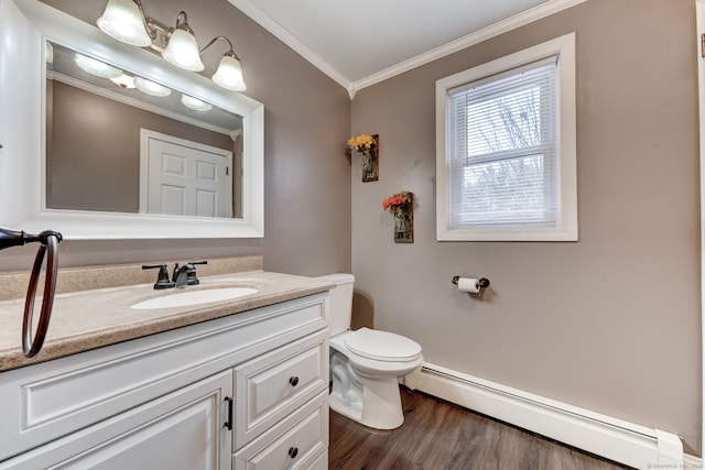 bathroom with crown molding, wood-type flooring, a baseboard heating unit, toilet, and vanity