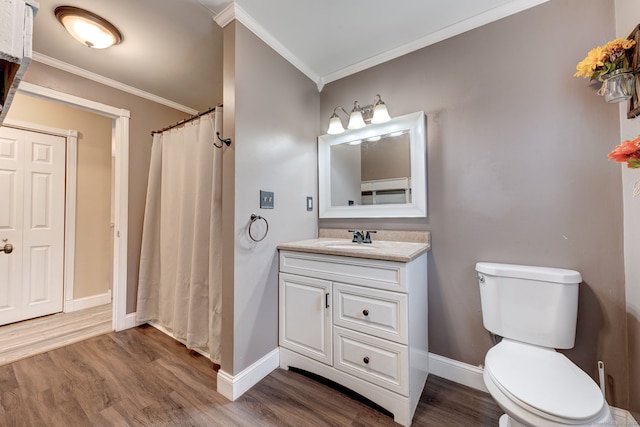 bathroom with hardwood / wood-style floors, toilet, vanity, and crown molding