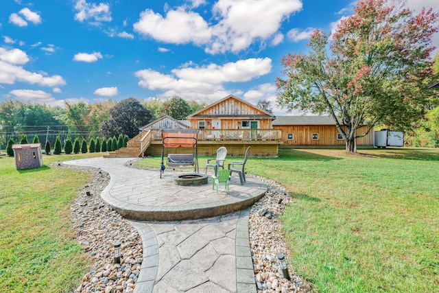 view of yard featuring a patio, a deck, and an outdoor fire pit