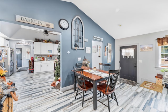 dining room with ceiling fan and lofted ceiling