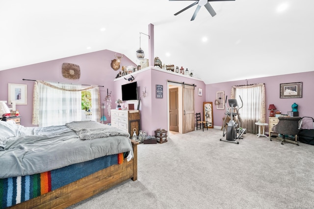 bedroom featuring multiple windows, a barn door, vaulted ceiling, and ceiling fan