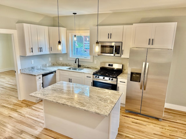 kitchen with sink, white cabinets, light hardwood / wood-style flooring, and appliances with stainless steel finishes