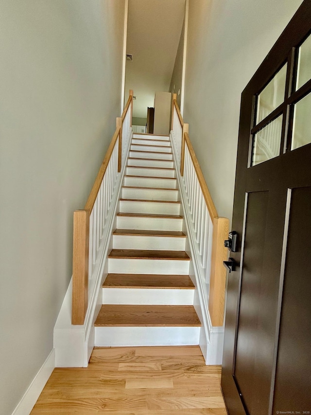 stairs featuring hardwood / wood-style flooring