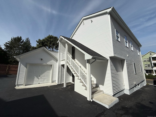 rear view of property featuring a garage