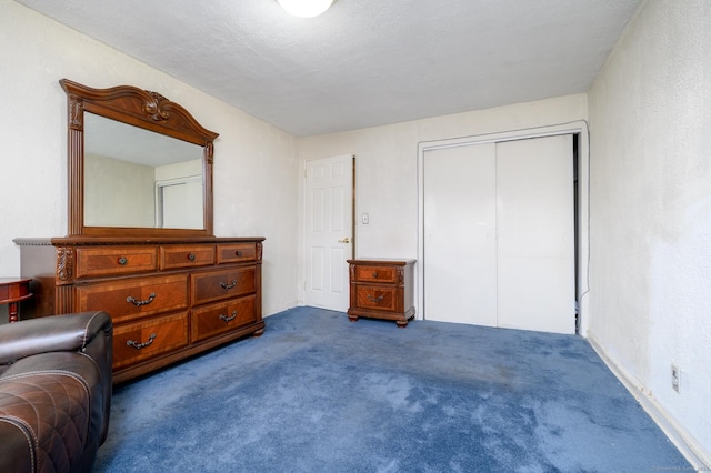 carpeted bedroom featuring a closet and a textured ceiling