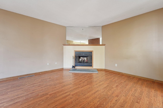 unfurnished living room with light hardwood / wood-style flooring