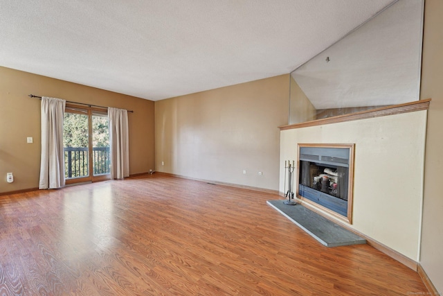 unfurnished living room with a textured ceiling and hardwood / wood-style floors