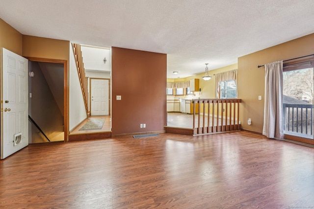 spare room featuring a textured ceiling and hardwood / wood-style floors