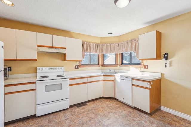 kitchen with white appliances, a textured ceiling, and white cabinets