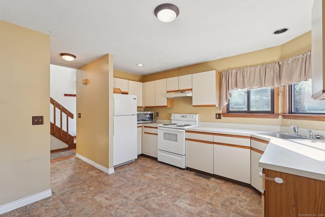 kitchen with white appliances, white cabinetry, a textured ceiling, and sink