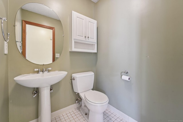 bathroom featuring toilet and tile patterned flooring