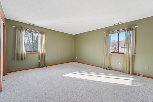 spare room with light colored carpet and plenty of natural light