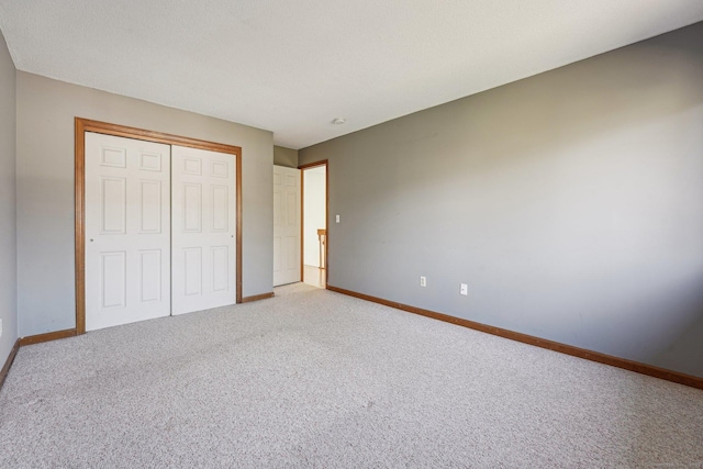 unfurnished bedroom featuring a closet and carpet flooring