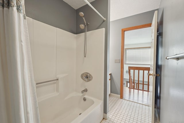 bathroom with tile patterned flooring, shower / bath combination with curtain, and a textured ceiling