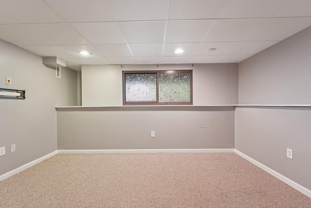 basement with carpet floors and a drop ceiling