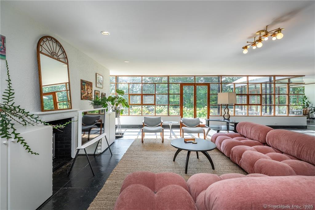 living room featuring a healthy amount of sunlight and a fireplace