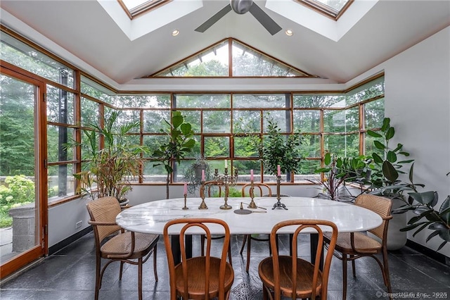 sunroom / solarium with ceiling fan and vaulted ceiling with skylight