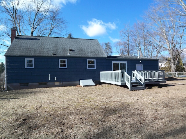 rear view of house featuring a yard and a wooden deck