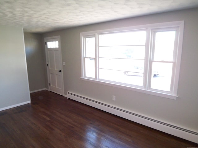 entrance foyer with a textured ceiling, dark hardwood / wood-style floors, and baseboard heating