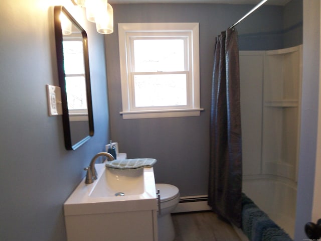 full bathroom with hardwood / wood-style floors, toilet, a healthy amount of sunlight, and a baseboard heating unit