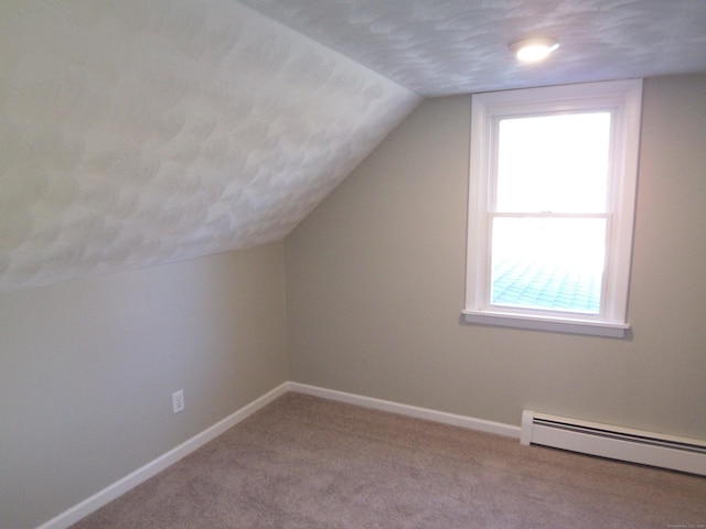 bonus room with baseboard heating, light carpet, a textured ceiling, and vaulted ceiling