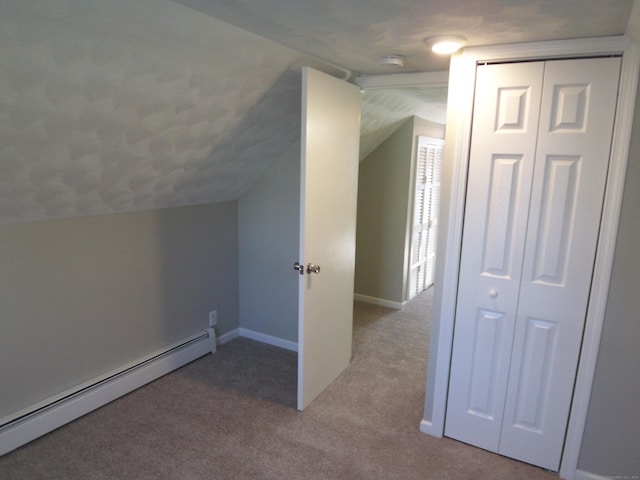 bonus room featuring carpet, vaulted ceiling, and a baseboard heating unit