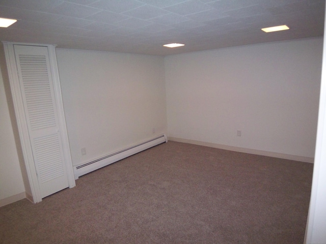 basement featuring carpet flooring and baseboard heating