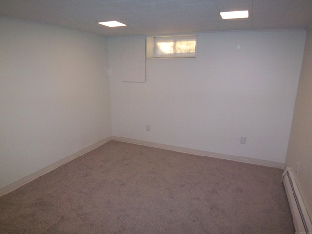 basement featuring carpet and a baseboard radiator