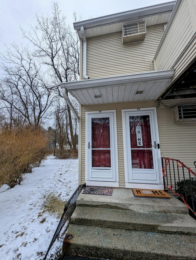 view of snow covered property entrance