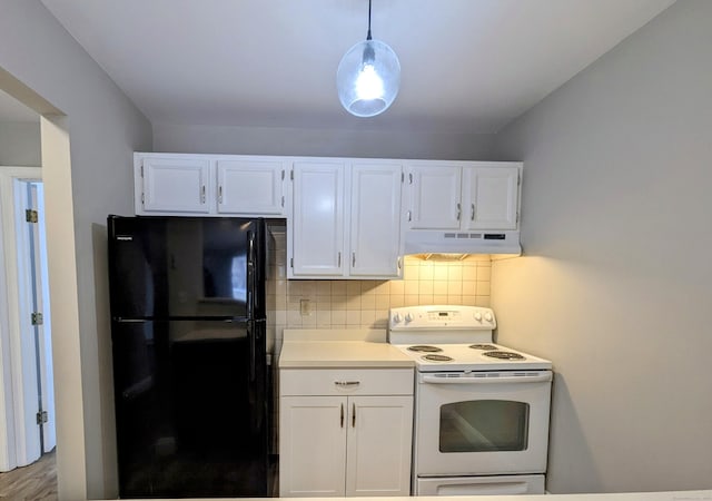 kitchen with black fridge, white cabinetry, hanging light fixtures, and electric range