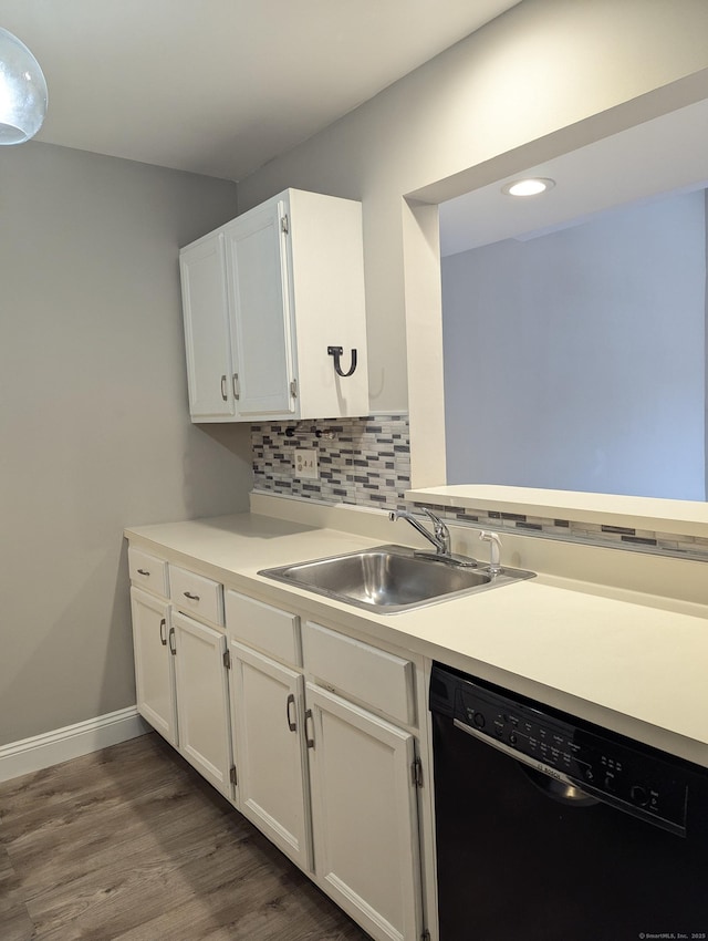 kitchen featuring dishwasher, sink, decorative backsplash, and white cabinets