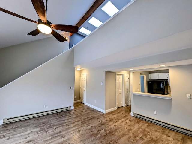 unfurnished living room with a baseboard heating unit, light hardwood / wood-style flooring, beamed ceiling, and ceiling fan