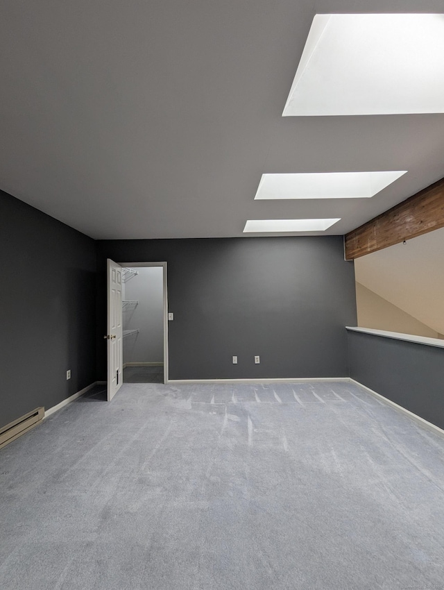 bonus room with lofted ceiling with skylight, light carpet, and a baseboard radiator