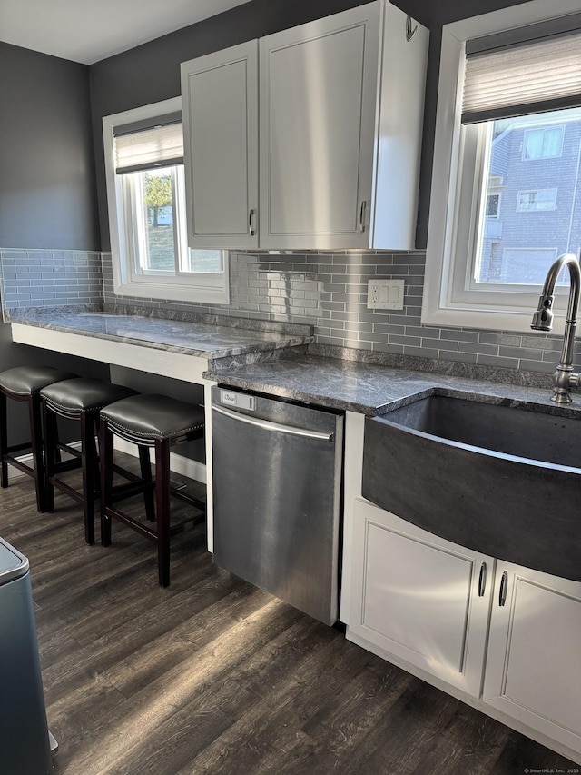 kitchen featuring decorative backsplash, white cabinets, dark wood-type flooring, sink, and dishwasher